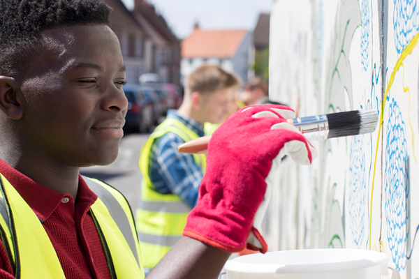 Students painting a mural in their community